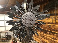 a large metal sunflower sitting on top of a table