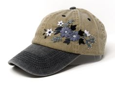 a baseball cap with embroidered flowers on it