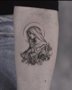 a black and white photo of a woman with flowers on her leg