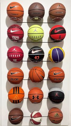 several basketballs are arranged on a wall in a display case at the nike museum