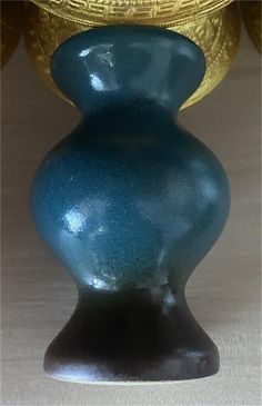 a blue vase sitting on top of a table