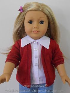 a doll with blonde hair wearing a red cardigan and blue jeans, standing on a white background