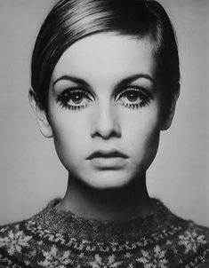 black and white photograph of a woman with short hair wearing an embellished top