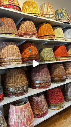 baskets are lined up on shelves in a store, and one is being viewed from the side