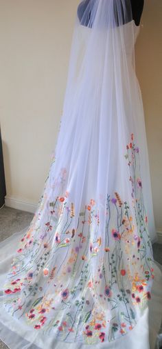 a white veil with colorful flowers on it