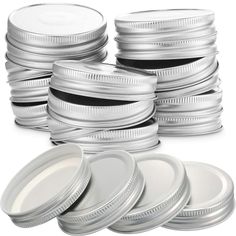 a stack of silver and black plates on a white background