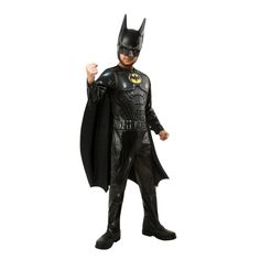 a young boy dressed up as batman in a black suit and mask with his fist raised