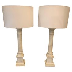 two white lamps sitting next to each other