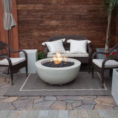 a fire pit sitting on top of a stone patio