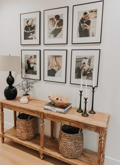 a wooden table with pictures on the wall