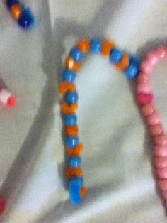 three beaded bracelets laying on top of a white sheet next to each other