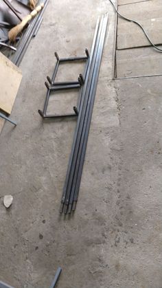 several metal bars laying on the ground next to each other in an unfinished room with concrete flooring