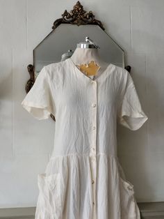 vintage creamy white cotton long  dress 100%cotton Made in Canada approx size M Excellent condition Measure are Soulder to shoulder 18inches sleeves 10inches bust42nches length:50inches Classic White Vintage Dress With Short Sleeves, Beige Cotton Vintage Dress For Summer, White Casual Vintage Dress For Daywear, White Cotton Vintage Dress For Summer, Cream Short Sleeve Vintage Dress For Summer, Cream Cottagecore Vintage Dress For Summer, Beige Vintage Dress With Short Sleeves For Daywear, Vintage White Linen Dresses, White Cotton Vintage Dress With Short Sleeves