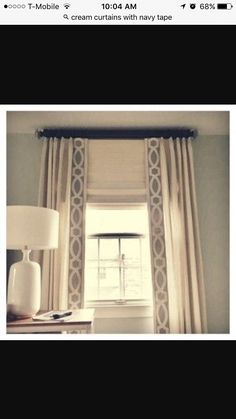 a window with curtains and a lamp next to it