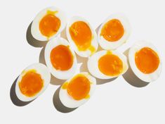 an overhead view of hard boiled eggs on a white surface