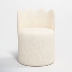 an upholstered chair with scalloped edges