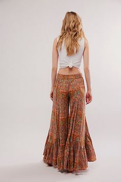 Our stunning Summer Kiss pants — now in a perfectly printed design! Featuring an ultra-wide-leg fit and godet pleating, this pair will turn heads with every wear. **Fit:** Mid-rise, exaggerated wide-leg silhouette **Features:** Pull-on design, godet pleating at the hem, bold abstract prints, lightweight fabrication **Why We ❤ It:** Beachy with sandals or sleek with strappy heels, this pair has endless ways to wear. | Summer Kiss Printed Godet Pants by Free People in Brown, Size: M Boho Wide Leg Pants, Summer Kiss, Flowing Pants, Boho Fits, Boho Clothes, Fall Pants, Ultra Wide, Boho Pants, Flowy Pants