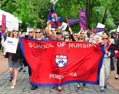 many people are marching down the street with signs and flags on their shoulders, some holding up red white and blue banners