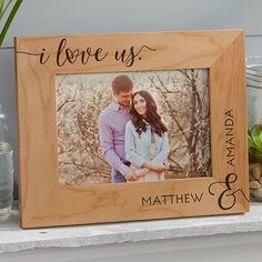 a wooden frame with the words i love you and an image of a couple