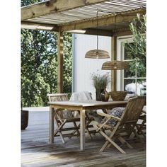 a wooden table and chairs on a deck