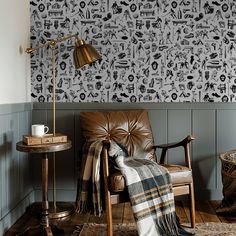 a chair and table in a room with wallpaper