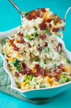 broccoli and bacon macaroni salad in a white dish with tongs