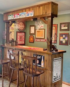 an old fashioned bar with wooden stools and signs on the wall behind it in a restaurant