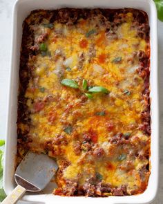 a casserole dish filled with meat and cheese