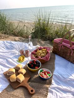 a picnic on the beach with fruit and bread