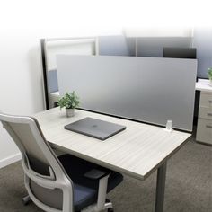 an office desk with a laptop on it