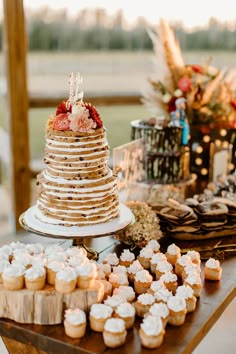 a table topped with lots of desserts and cupcakes on top of it