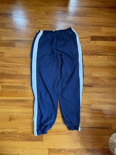 This is amazing. Would be a perfect throwback item in any collection/wardrobe. Also would be a great gift. Don't miss out on this one.    Condition is exactly as pictured.    Size XL.    Please make sure you know what you're ordering because there are no returns or cancellations. Thank you!! Nike Track Pants Blue, Casual Activewear With Side Stripes And Relaxed Fit, Blue Cotton Sweatpants With Side Stripes, Navy Sweatpants For Streetwear, Casual Blue Joggers With Three Stripes, Blue Sweatpants With Side Stripes For Streetwear, Casual Activewear With Side Stripes, Navy Sporty Pants With Three Stripes, Sporty Navy Pants With Three Stripes