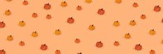 an orange background with small leaves on it