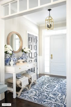 a white and blue entryway with an ornate rug