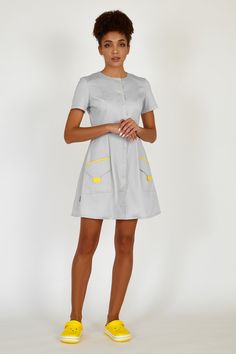 This fashionable uniform dress will make any female doctor or a beautician look stylish and classy when at work. The medical lab coat has a babydoll design, a full skirt, and 3/4 sleeves. The scrub dress has contrast snap fastening. The dress is complemented with laconic and roomy patch pockets that are trimmed with contrast fabric. The fabric is 70% cotton, 30% polyester, made in the Netherlands. Your customers will get aesthetic pleasure when communicating with you wearing this apparel, while Esthetician Uniform, Dentist Clothes, Cleaning Uniform, Scrub Dress, Women Doctor, Nurse Dress Uniform, Best Uniforms, Doctor Coat, Scrubs Nursing Uniforms