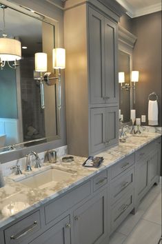 a large bathroom with double sinks and mirrors