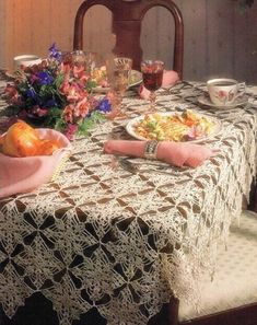 a table topped with plates of food and flowers