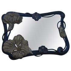 a decorative mirror with flowers on it