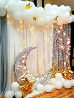 a balloon arch decorated with stars and moon balloons