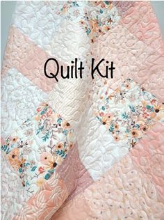 the quilt kit is made with pink, white and blue flowers on it's sides