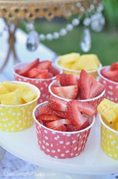 small cups filled with strawberries and pineapples