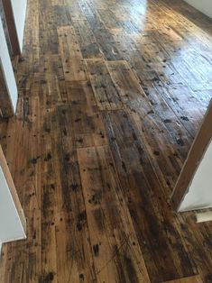 an empty room with wooden floors and white walls