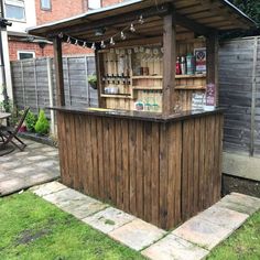 a small wooden bar in the back yard