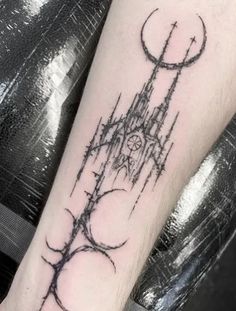 a tattoo on the arm of a person with a clock tower in front of it