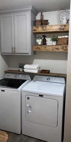 a white washer and dryer sitting next to each other in a laundry room