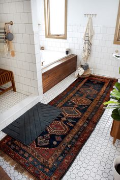 a bathroom that has a rug on the floor