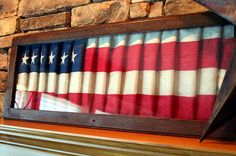 an american flag painted on the side of a fireplace mantel in front of a stone wall