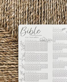 the printable bible calendar is sitting on top of a wicker tablecloth, next to a woven basket