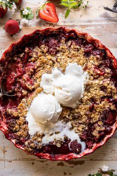 a bowl filled with ice cream and strawberries