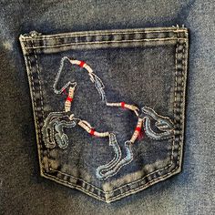 5 Pocket Design Jeans With Patriotic Embroidered Horse On The Back Pockets. Button, Zip Fly, Functional Pockets, Size Xxl. Approximate Equal To Size 14 Womens. Functional Belt Loops. Straight Leg. Blended Fabric To Include Cotton, Polyester And Spandex For Stretch And Comfort. Needle Point Jeans, Denim Pocket Embroidery, Patched Clothes, Jean Pocket Designs, American Embroidery, Embroidered Horse, Horse Fabric, American Flag Sweater, Denim Embroidery